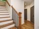 Elegant staircase with wooden steps and railings, complemented by sleek black iron balusters at 1523 Havenmont Ct, Raleigh, NC 27608