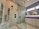 Modern bathroom featuring a glass shower with matte black fixtures and double vanity at 1525 Havenmont Ct, Raleigh, NC 27608