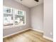 Bright bedroom with large windows, neutral paint, and wood-look floors offering a peaceful and inviting atmosphere at 1525 Havenmont Ct, Raleigh, NC 27608