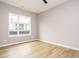 An empty bedroom with wood-look flooring and a large window providing natural light at 1525 Havenmont Ct, Raleigh, NC 27608