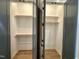Walk-in closet with ample space and rod-and-shelf storage on both sides at 1525 Havenmont Ct, Raleigh, NC 27608