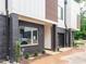 Townhouse exterior displaying a brick facade, modern design, and newly landscaped front yard at 1525 Havenmont Ct, Raleigh, NC 27608