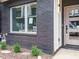 A townhouse entrance featuring a brick facade, modern front door and recently landscaped front yard at 1525 Havenmont Ct, Raleigh, NC 27608