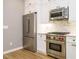 Kitchen featuring stainless steel appliances including refrigerator, gas range, and wood flooring at 1525 Havenmont Ct, Raleigh, NC 27608