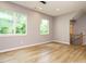 Spacious room with wood floors and abundant natural light from large windows at 1525 Havenmont Ct, Raleigh, NC 27608