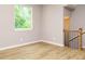 Bright room with wood floors and a large window, showcasing the staircase at 1525 Havenmont Ct, Raleigh, NC 27608