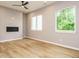 Bright, open living room with wood floors, a modern fireplace, and large windows at 1525 Havenmont Ct, Raleigh, NC 27608