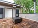 This roof deck features an interesting parquet-pattern wood decking and a modern fire pit, perfect for outdoor enjoyment at 1525 Havenmont Ct, Raleigh, NC 27608