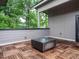 Stylish rooftop deck boasting wood-tiled flooring and views of the surrounding trees at 1525 Havenmont Ct, Raleigh, NC 27608
