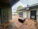 Modern rooftop deck showcasing wood-tiled flooring and an outdoor fire pit area at 1525 Havenmont Ct, Raleigh, NC 27608