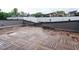 Spacious rooftop deck featuring wood-tiled flooring and a contemporary outdoor living space at 1525 Havenmont Ct, Raleigh, NC 27608