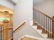 An open staircase featuring wood treads, white risers, and dark metal balusters at 1525 Havenmont Ct, Raleigh, NC 27608