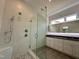 Bathroom featuring tiled shower with glass door and double sink vanity at 1527 Havenmont Ct, Raleigh, NC 27608