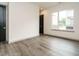 Bright bedroom features wood-look flooring, neutral paint, and a large window at 1527 Havenmont Ct, Raleigh, NC 27608