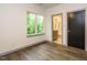 Comfortable bedroom with wood floors, window, and en suite bathroom at 1527 Havenmont Ct, Raleigh, NC 27608