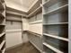 Walk-in closet with shelving and clothes rods for optimal organization at 1527 Havenmont Ct, Raleigh, NC 27608