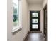 Clean, modern entryway with a black door and hardwood flooring at 1527 Havenmont Ct, Raleigh, NC 27608