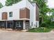 New, modern townhome showcasing its exterior with brick and modern lines at 1527 Havenmont Ct, Raleigh, NC 27608
