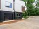 Townhome featuring a modern garage with dark brick and black garage door at 1527 Havenmont Ct, Raleigh, NC 27608