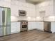 Modern kitchen featuring stainless steel appliances and white cabinetry at 1527 Havenmont Ct, Raleigh, NC 27608