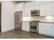 Bright kitchen with stainless steel appliances and crisp white cabinets at 1527 Havenmont Ct, Raleigh, NC 27608
