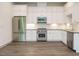 Open kitchen showcasing stainless steel appliances and white cabinets at 1527 Havenmont Ct, Raleigh, NC 27608
