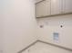 Functional laundry area with neutral cabinets and modern flooring at 1527 Havenmont Ct, Raleigh, NC 27608