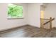 Bright living room with large window offering natural light and sleek wood flooring at 1527 Havenmont Ct, Raleigh, NC 27608