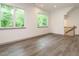 Open living room with hardwood floors, large windows, and natural light at 1527 Havenmont Ct, Raleigh, NC 27608