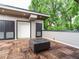 Rooftop deck with wood tile flooring and a modern fire pit table and two storage units at 1527 Havenmont Ct, Raleigh, NC 27608