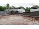 Wide rooftop deck with wood tile flooring and gray paneled surround with modern architecture at 1527 Havenmont Ct, Raleigh, NC 27608