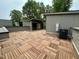 Rooftop deck with wood tile flooring and gray paneled surround and a condensing unit at 1527 Havenmont Ct, Raleigh, NC 27608