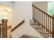 Modern staircase with wooden railings and black metal balusters at 1527 Havenmont Ct, Raleigh, NC 27608