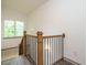 Modern staircase with wood and black metal railing with modern light fixtures at 1527 Havenmont Ct, Raleigh, NC 27608