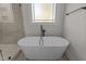 Bathroom featuring a freestanding bathtub and marble tile at 143 Hook Dr # 23, Fuquay Varina, NC 27526