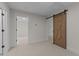 Spacious bedroom with doorways leading to other rooms, and a rustic sliding barn door at 143 Hook Dr # 23, Fuquay Varina, NC 27526