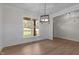 Dining room with large window, hardwood floors, and chandelier at 143 Hook Dr # 23, Fuquay Varina, NC 27526