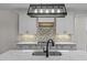 Modern kitchen with a farmhouse sink, white cabinets and quartz countertops at 143 Hook Dr # 23, Fuquay Varina, NC 27526