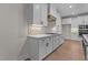 Modern kitchen with white cabinets, gas cooktop, and designer backsplash at 143 Hook Dr # 23, Fuquay Varina, NC 27526