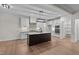 Modern kitchen with white cabinets, quartz countertops, and a large island at 143 Hook Dr # 23, Fuquay Varina, NC 27526