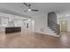 Open living room features hardwood floors, high ceilings and a view of the kitchen and staircase at 143 Hook Dr # 23, Fuquay Varina, NC 27526