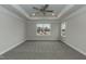 Spacious carpeted bedroom showcasing a tray ceiling with fan and natural light from large windows at 138 New Twin Branch Ct, Smithfield, NC 27577