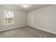 Bedroom with neutral walls and carpet and one window and white closet door at 138 New Twin Branch Ct, Smithfield, NC 27577