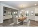 Open-concept dining and living area with a modern table set and a view of the fireplace at 138 New Twin Branch Ct, Smithfield, NC 27577