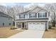 Beautiful two-story home with gray siding, black shutters, and a spacious two-car garage at 138 New Twin Branch Ct, Smithfield, NC 27577