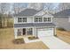 Attractive two-story home featuring stone accents, an attached two-car garage, and a welcoming entrance at 138 New Twin Branch Ct, Smithfield, NC 27577