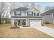 Attractive two-story home featuring stone accents, an attached two-car garage, and a welcoming entrance at 138 New Twin Branch Ct, Smithfield, NC 27577