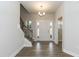 Bright foyer features wood-look floors, a staircase with iron spindles, and an elegant chandelier at 138 New Twin Branch Ct, Smithfield, NC 27577