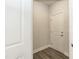 Hallway featuring a white door, neutral walls, and wood-look flooring at 138 New Twin Branch Ct, Smithfield, NC 27577