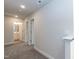 Neutral-toned hallway with carpet flooring and white doors leading to various rooms at 138 New Twin Branch Ct, Smithfield, NC 27577